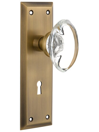 New York Plate with Oval Clear Crystal Knobs with Keyhole in Antique Brass.